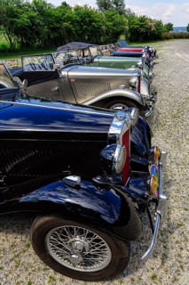 Various classic cars behind each other
