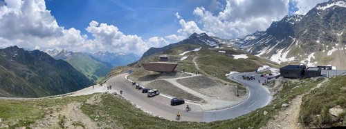 Panoramic view of pass road Alpine pass mountain road pass height of 2509 metres high Timmelsjoch Passo Rombo with pass museum rises from right Austrian territory to left in air of Italian territory