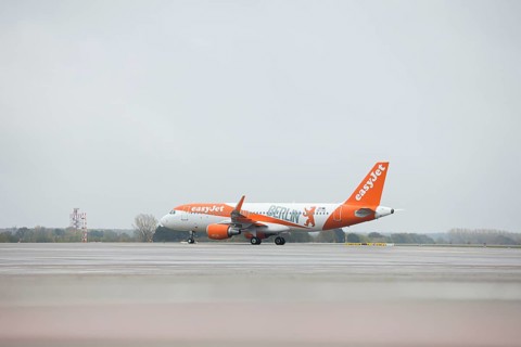 An EasyJet aircraft with the inscription Berlin taxis across the tarmac at BER Airport. Schoenefeld