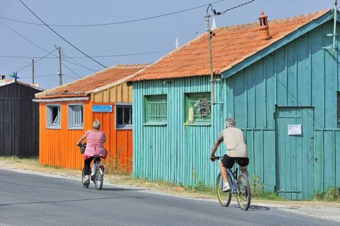 Colourful cabins of oyster farm at la Baudissiere near Dolus