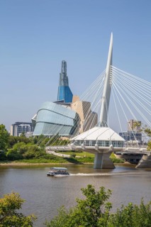 View from the Tache Promenade of the Red River with Provencher Bridge and the Winnipeg skyline behind it