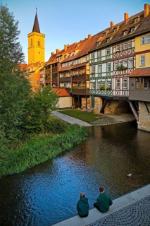 Half-timbered houses of the Kraemerbruecke with the river Gera and the Aegidienkirche