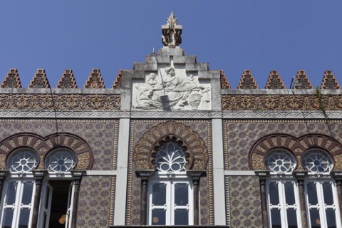 Ceramic tile facade with horseshoe window