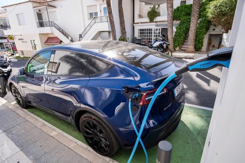 Tesla electric vehicle charging at a charging station in the village of Altea La Vella