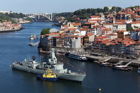 View of Ribeira district and Douro river with frigate NRP D. Francisco da Almeida