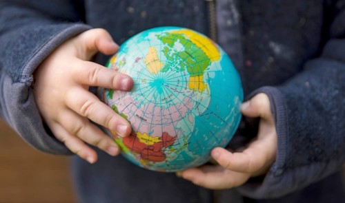 Save the Earth. Child holding a globe in the band
