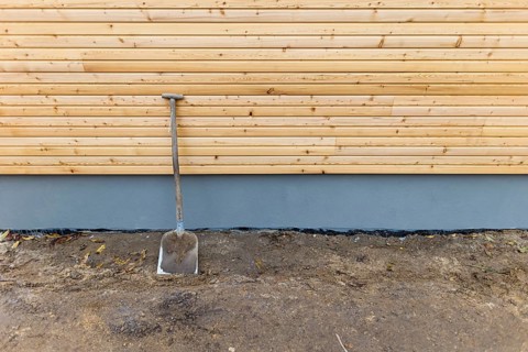 A shovel is leaning against a wall at a construction site. Berlin