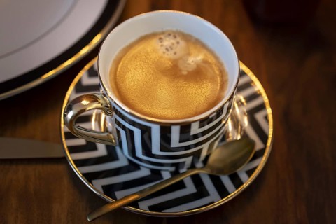 Breakfast with a coffee in a luxurious cup.