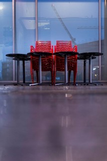 Assembled chairs and tables stand out in front of a closed cafe in Berlin