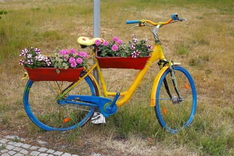 Colourful bicycle decorated with flowers and flower boxes