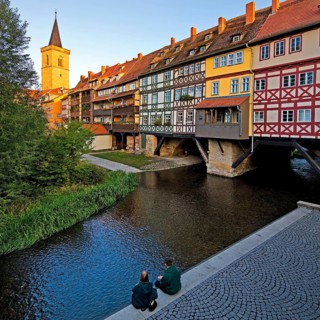 Half-timbered houses of the Kraemerbruecke with the river Gera and the Aegidienkirche