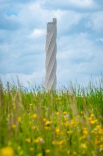Thyssen Krupp test tower behind flower meadow in spring
