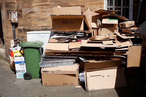 Cartons and stacks of waste paper