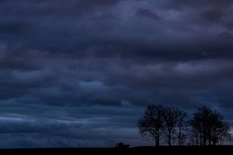 A van stands out at blue hour on a country road in Vierkirchen