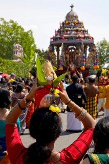 Woman in sari with offerings to the goddess on the main festival day at the big procession Theer