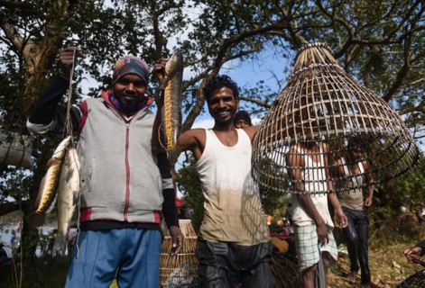 Villagers participate in a community fishing event on the occasion of Bhogali Bihu Festival at Goroimari Lake in Panbari village