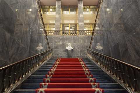 Pompous black marble staircase with red carpet