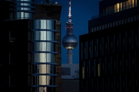The TV tower looms behind office buildings in Berlin