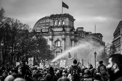 Police officers act with water cannons against demonstrators protesting against the reform of the infection protection law in Berlin