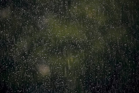 Raindrops hang on a window pane. Berlin