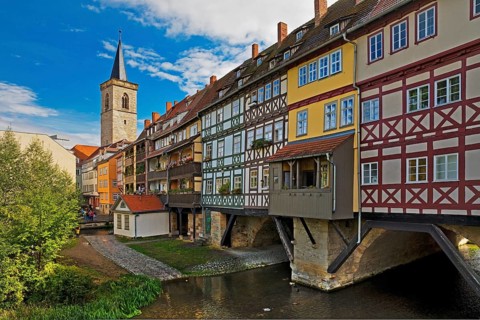 Half-timbered houses of the Kraemerbruecke with the river Gera and the Aegidienkirche