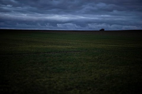 A car stands out on a country road at blue hour in Vierkirchen