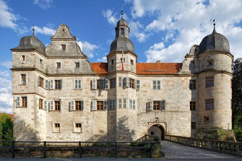North-west side of Mitwitz moated castle with stone bridge and entrance portal