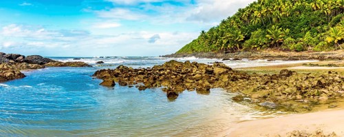 Sea between vegetation and rocks at Prainha beach in Serra Grande on the south coast of Bahia