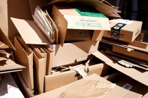 Cartons and stacks of waste paper