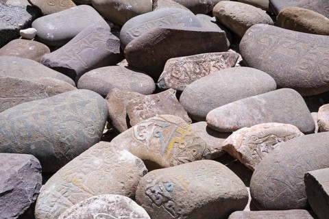 Mani stones with the engraved Tibetan mantra Om Mani Padme Hum