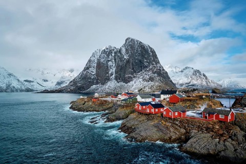Hamnoy fishing village with red rorbu houses in Norwegian fjord in winter. Lofoten Islands
