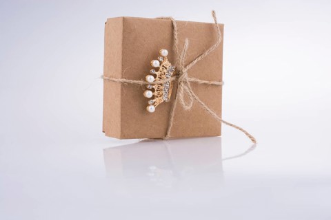 Golden color crown model with pearls on white background