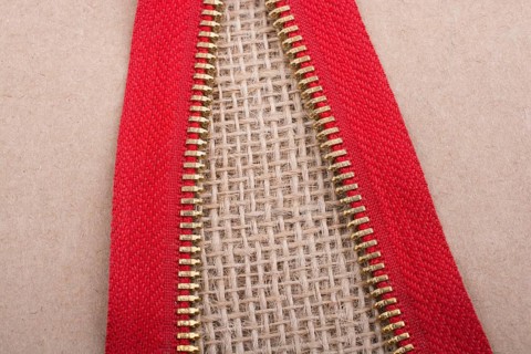 Closeup of a colorful zipper on linen canvas