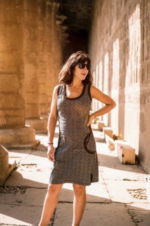 Portrait of a young brunette on the columns of the Edfu Temple near the city of Aswan. Egypt