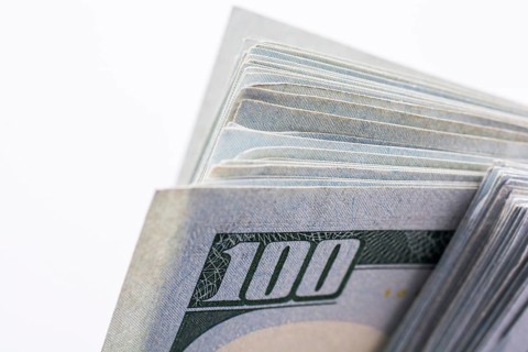 American 100 dollar banknotes made of paper placed on white background