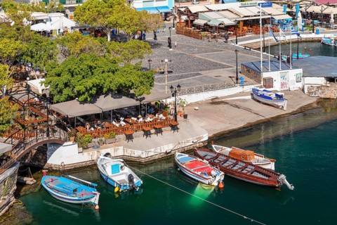 Fishing boats on Lake Voulismeni at the harbour promenade