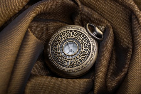 Mechanical retro styled pocket watch on fabric