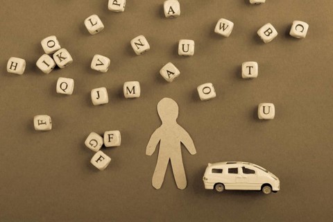 Letter cubes of made of wood and man figurine