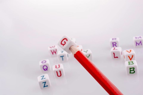 Pencil with Letter cubes on a white background