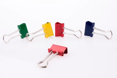 Colored paper clips on a white background