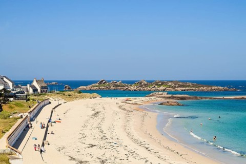 Bay with sandy beach and granite rocks
