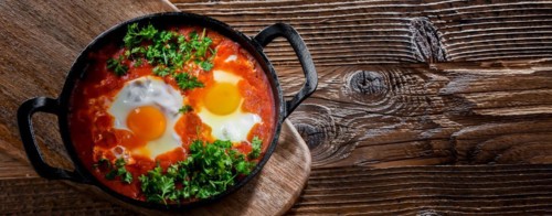 Shakshouka dish in a cast iron pan