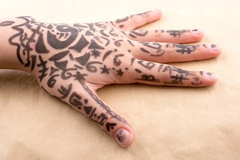 Hand with tattoo on a background