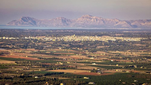 View from mountain Puig Santa Magdalena to the north coast of Majorca with village Muro and peninsula Llevant