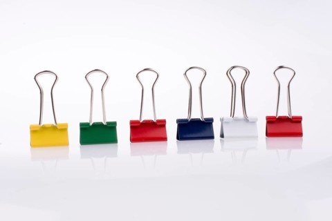Colored paper clips on a white background