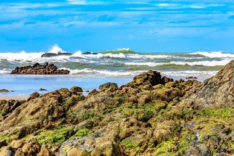 Rocky beach with waves crashing against the rocks in Serra Grande on the coast of Bahia