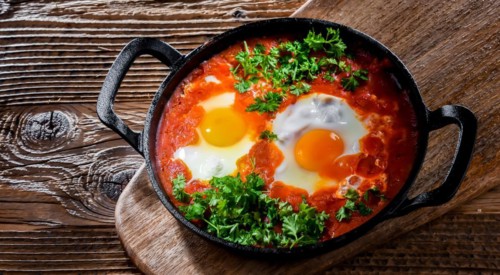 Shakshouka dish in a cast iron pan