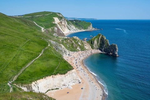 View over the chalk coast with the famous rock bridge Durdledoor