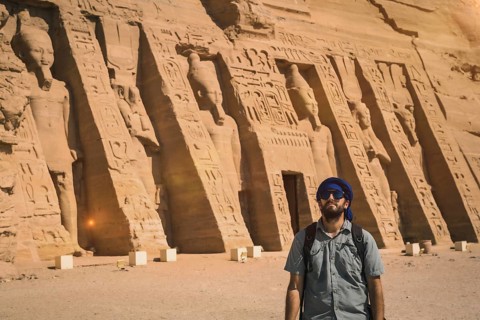 A young man wearing a blue turban visiting the Egyptian Temple of Nefertari near Abu Simbel in southern Egypt in Nubia next to Lake Nasser. Temple of Pharaoh Ramses II