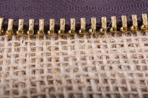 Closeup of a colorful zipper on linen canvas